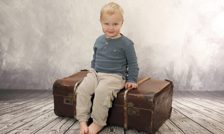 Kindergarten Bild Kind sitzend auf Koffer